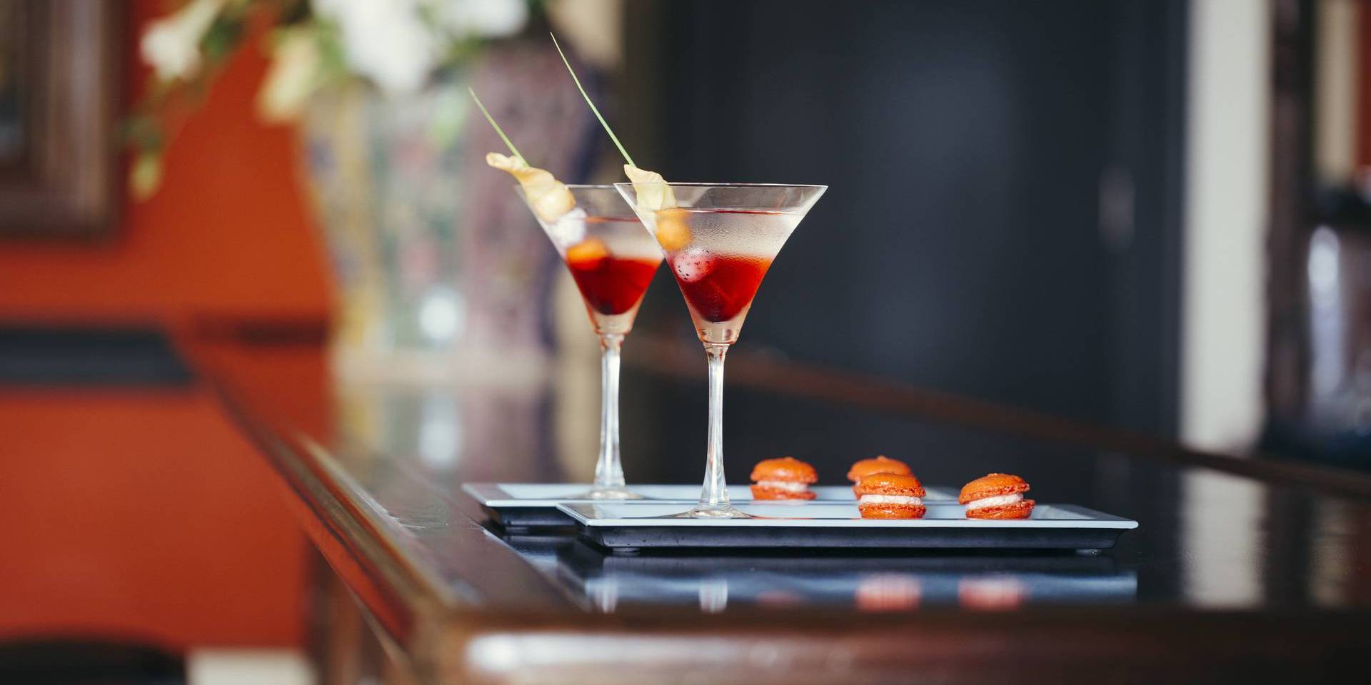 Close up of two cocktails on a tray.